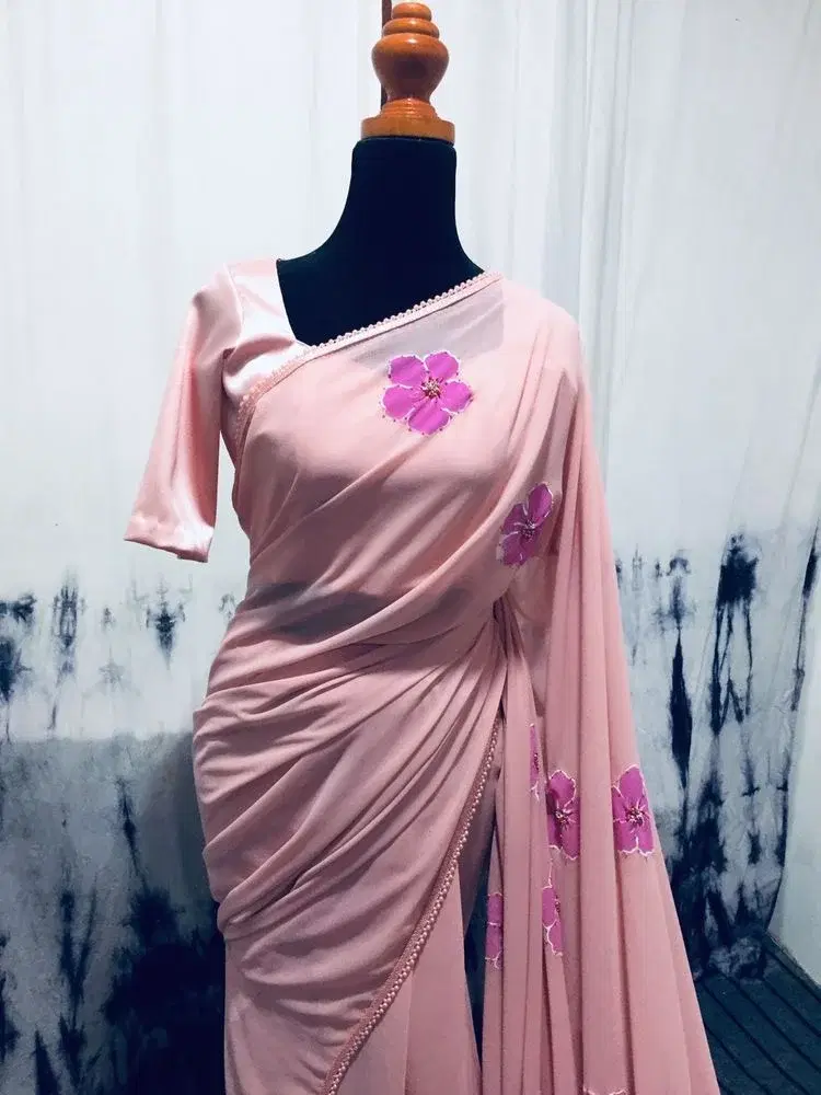Embrace soft, romantic elegance with this stunning blush pink floral saree, designed for a flawless and graceful drape. view 2